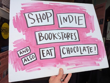 pink sign says SHOP INDIE BOOKSTORES AND EAT CHOCOLATE