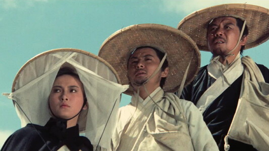 Three people in straw hats. One a woman, the other two are men. 